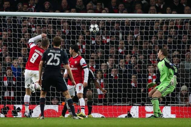 Football - 2012 2013 Champions League - Round of 16, First Leg: Arsenal vs. Bayern Munich Lukas Podolski of Arsenal scoring at the Emirates Stadium, London 