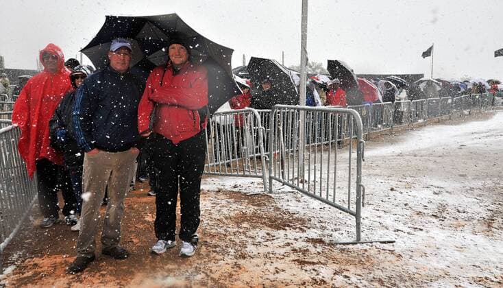 Fans wait in line in the snow after the first round of the Accenture World Golf Championship at The Golf Club at Dove Mountain was suspended due to the snow in Marana, Arizona February 20, 2013.  PXP2013022007