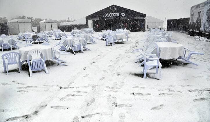 Chairs and tables are covered with snow at the concession stand after suspension of the first round of the Accenture World Golf Championship at The Golf Club at Dove Mountain in Marana, Arizona February 20, 2013.  PXP2013022015