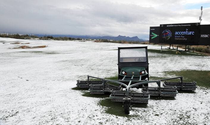 A driving range tractor sits in the show that suspended the first round of the Accenture World Golf Championship at The Golf Club at Dove Mountain in Marana, Arizona February 20, 2013.  PXP2013022017