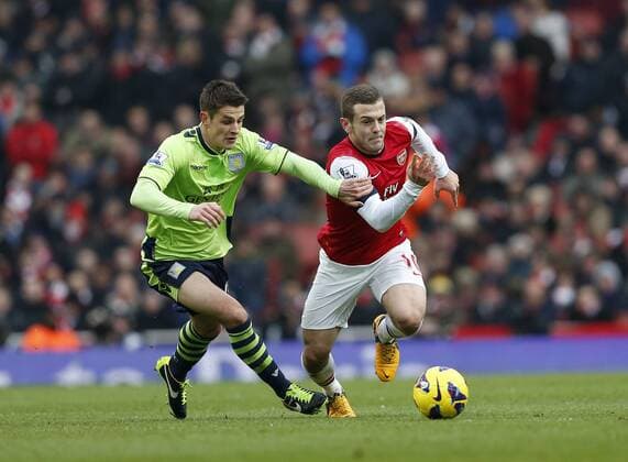 Arsenal FC London s Jack Wilshere tussles with Aston Villa s Matthew Lowton ..Arsenal FC London v Aston Villa - Premier League - Emirates Stadium, London- 23 02 13 - EDITORIAL USE ONLY. No use with unauthorised audio, video, data, fixture lists, club league logos or live services. Online in-match use limited to 120 images, no video emulation. No use in betting, games or single club league player publications.