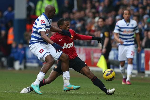 Football - 2012 2013 Premier League - Queens Park Rangers vs. Manchester United (ManU) Manchester United (ManU) s Patrice Evra and Stephane Mbia of Queens Park Rangers at Loftus Road, London 