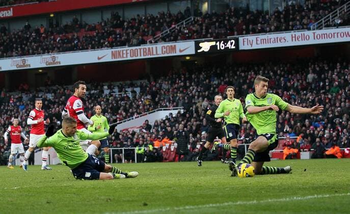 Arsenal FC London s Santi Cazorla scoring his second goal..Arsenal FC London v Aston Villa - Premier League - Emirates Stadium, London- 23 02 13 - EDITORIAL USE ONLY. No use with unauthorised audio, video, data, fixture lists, club league logos or live services. Online in-match use limited to 120 images, no video emulation. No use in betting, games or single club league player publications.