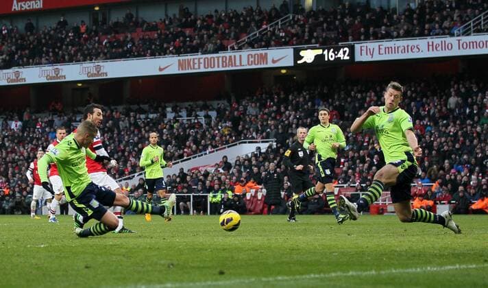 Arsenal FC London s Santi Cazorla scoring his second goal..Arsenal FC London v Aston Villa - Premier League - Emirates Stadium, London- 23 02 13 - EDITORIAL USE ONLY. No use with unauthorised audio, video, data, fixture lists, club league logos or live services. Online in-match use limited to 120 images, no video emulation. No use in betting, games or single club league player publications.