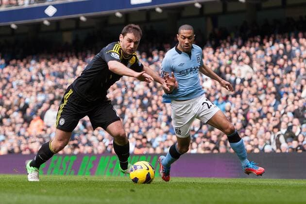 Football - 2012 2013 Premier League - Manchester City vs. Chelsea Gael Clichy of Manchester City rounds Branislav Ivanovic of Chelsea at the Etihad Stadium 