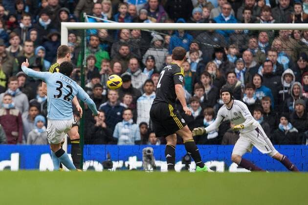 Football - 2012 2013 Premier League - Manchester City vs. Chelsea FC London - Carlos Tevez of Manchester City strikes to score his sides second goal at the Etihad Stadium 