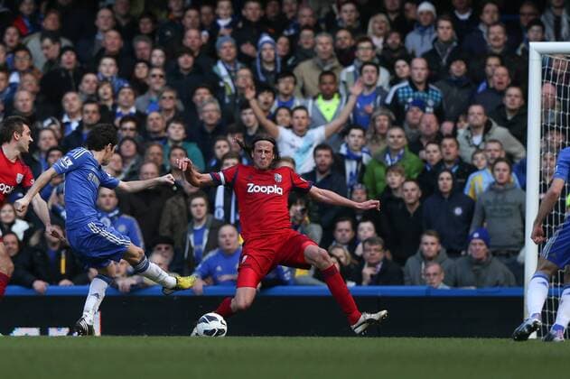 Football - 2012 2013 Premier League - Chelsea FC London vs. West Bromwich Albion - Oscar of Chelsea has a shot on goal blocked by Jonas Olsson of West Bromwich Albion at Stamford Bridge, London 