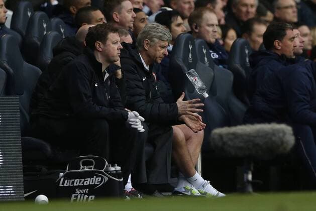 Football - 2012 2013 Premier League -Tottenham Hotspur vs Arsenal Manager of Arsenal Arsene Wenger drops his water bottle at White Hart Lane, London 