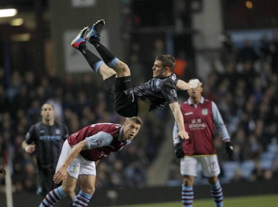 James Milner of Manchester City climbs high above Villa defender Nathan Baker - Football - Aston Villa vs Manchester City - Barclays Premier League Season 12 13 - 4 3 2013 - Villa Park - Birmingham.Picture Malcolm Couzens Sportimage EDITORIAL USE ONLY. No use with unauthorised audio, video, data, fixture lists, club league logos or live services. Online in-match use limited to 120 images, no video emulation. No use in betting, games or single club league player publications.