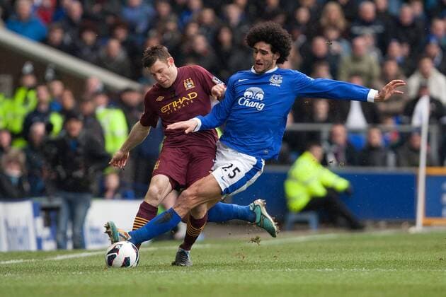 Football - 2012 2013 Premier League - Everton vs. Manchester City Marouane Fellaini of Everton challenges James Milner of Manchester City to earn a yellow card at Goodison Park 