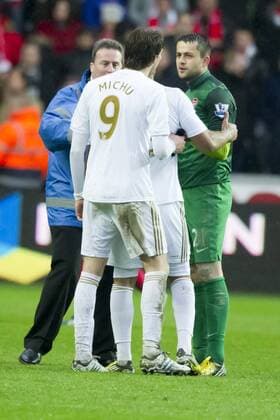 Football - 2012 2013 Premier League - Swansea City vs. Arsenal FC London 0:2 - stewards break up a conversation between luke moore and lukasz fabianski after the game.