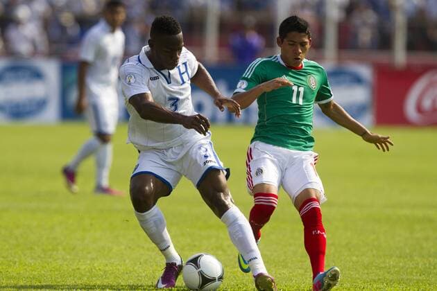 (130323) -- SAN PEDRO SULA, March 22, 2013 (Xinhua) -- Honduras Maynor Figueroa (L) vies for the ball with Mexico s Javier Aquino during the Brazil-2014 FIFA World Cup CONCACAF soccer qualifier match at Olimpico Metropolitano stadium in San Pedro Sula, Honduras, on March 22, 2013. The match ended with a 2-2 draw. (Xinhua StraffonImages) (mp) HONDURAS-SAN PEDRO SULA-HONDURAS VS MEXICO 