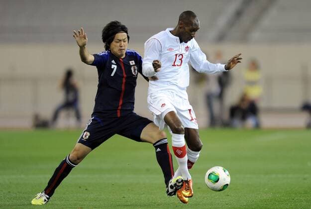 (130323) -- DOHA, March 22, 2013 (Xinhua) -- Endo Yasuhito (L) of Japan vies with Atiba Hutchinson of Canada during their international friendly match at Khalifa Stadium in Doha, Qatar, on March 22, 2013. Japan won 2-1. (Xinhua Chen Shaojin) (lm) QATAR-DOHA-SOCCER-INTERNATIONAL FRIENDLY-JPN VS. CAN 