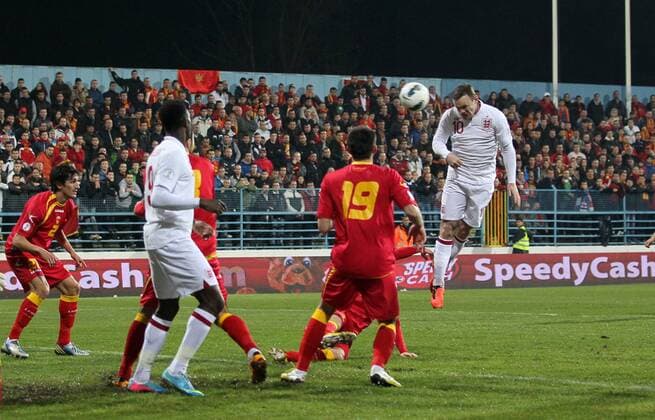 England s Wayne Rooney scoring his sides opening goal..Montenegro v England- World Cup Qualifier - Podgorica City Stadium, Podgorica- 26 03 13 - Picture David Klein Sportimage EDITORIAL USE ONLY. No use with unauthorised audio, video, data, fixture lists, club league logos or live services. Online in-match use limited to 120 images, no video emulation. No use in betting, games or single club league player publications.