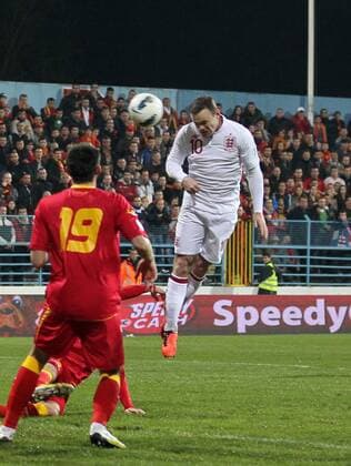 England s Wayne Rooney scoring his sides opening goal..Montenegro v England- World Cup Qualifier - Podgorica City Stadium, Podgorica- 26 03 13 - Picture David Klein Sportimage EDITORIAL USE ONLY. No use with unauthorised audio, video, data, fixture lists, club league logos or live services. Online in-match use limited to 120 images, no video emulation. No use in betting, games or single club league player publications.