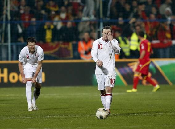 England s Wayne Rooney looks on dejected after Montenegro s goal..Montenegro v England- World Cup Qualifier - Podgorica City Stadium, Podgorica- 26 03 13 - Picture David Klein Sportimage EDITORIAL USE ONLY. No use with unauthorised audio, video, data, fixture lists, club league logos or live services. Online in-match use limited to 120 images, no video emulation. No use in betting, games or single club league player publications.