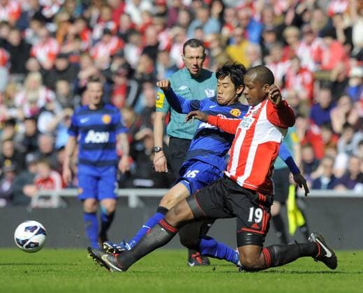 Shinji Kagawa of Manchester United (L) is challenged by Titus Bramble of Sunderland - Barclays Premier League - Sunderland AFC (FC) - Manchester United (ManU) - Stadium of Light - Sunderland - 30 03 13 - PictureRichardLee Sportimage EDITORIAL USE ONLY. No use with unauthorised audio, video, data, fixture lists, club league logos or live services. Online in-match use limited to 120 images, no video emulation. No use in betting, games or single club league player publications.