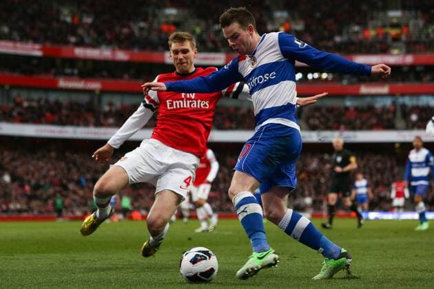 Football - 2012 2013 Premier League - Arsenal FC London - Reading FC; Reading s Danny Gutherie and Per Mertesacker of Arsenal at the Emirates Stadium 