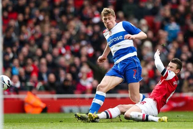 Football - 2012 2013 Premier League - Arsenal FC London - Reading FC; Reading s Pavel Pogrebnyak has a shot blocked by Aaron Ramsey of Arsenal at the Emirates Stadium 
