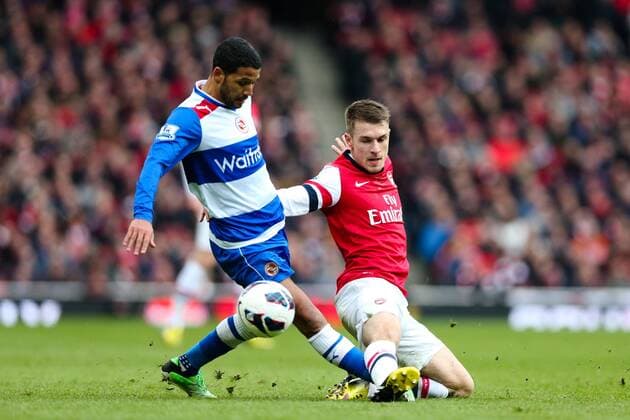 Football - 2012 2013 Premier League - Arsenal FC London - Reading FC; Reading s Jobi McAnuff and Aaron Ramsey of Arsenal at the Emirates Stadium 