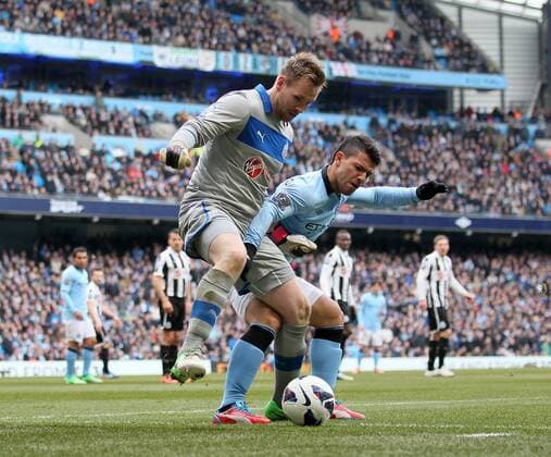 Manchester City s Kun Sergio Aguero tussles with Newcastle s Rob Elliot..Manchester City v Newcastle United- Barclays Premier League - City Of Manchester Stadium, Manchester- 30 03 13 - Picture David Klein Sportimage EDITORIAL USE ONLY. No use with unauthorised audio, video, data, fixture lists, club league logos or live services. Online in-match use limited to 120 images, no video emulation. No use in betting, games or single club league player publications.
