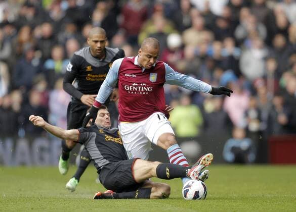 Steven Gerrard of Liverpool lunges at Gabriel Agbonlahor of Aston Villa - Aston Villa vs Liverpool - Barclays Premiership - Villa Park Birmingham - Season 12 13 - 31 3 13.Photograph Malcolm Couzens Sportimage EDITORIAL USE ONLY. No use with unauthorised audio, video, data, fixture lists, club league logos or live services. Online in-match use limited to 120 images, no video emulation. No use in betting, games or single club league player publications.