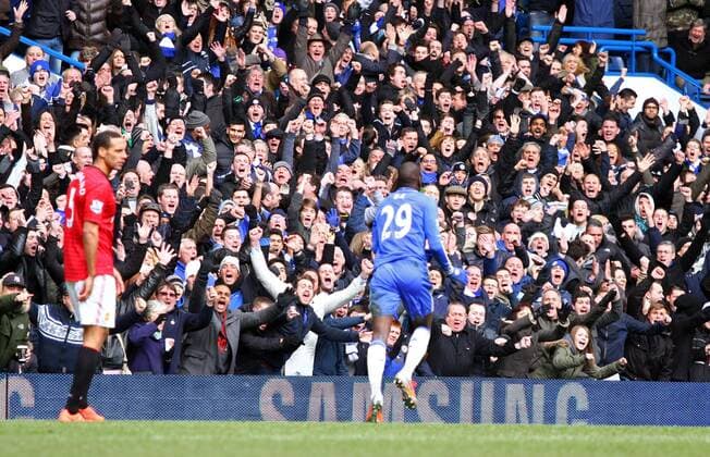 Pic: Paul Marriott . . Chelsea v Manchester United - FA Cup Quarter-Final replay . . 01.04.13 Chelsea fans go wild as Demba Ba (C) celebrates scoring a goal for Chelsea, past Rio Ferdinand (MU). 