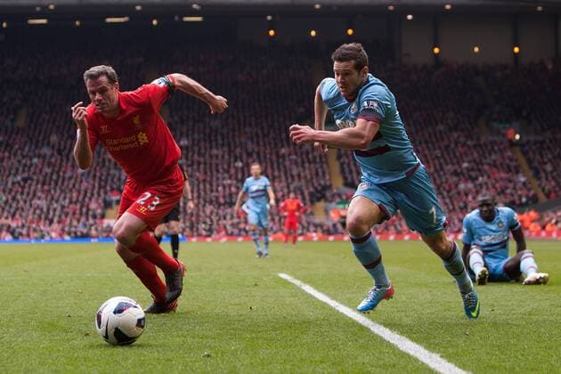 Football - 2012 2013 Premier League. Liverpool FC - West Ham United, Jamie Carragher of Liverpool and West Ham s Matt Jarvis chase down a loose ball at Anfield 