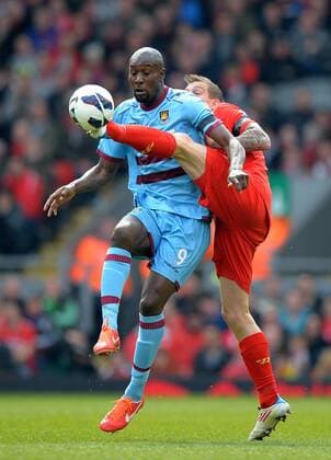 Daniel Agger of Liverpool challenges Carlton Cole of West Ham United - Barclays Premier League - Liverpool FC - West Ham United. Anfield Stadium - Liverpool - England - 07 04 13 - EDITORIAL USE ONLY. No use with unauthorised audio, video, data, fixture lists, club league logos or live services. Online in-match use limited to 120 images, no video emulation. No use in betting, games or single club league player publications.