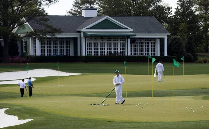 Course workers maintain the practice green at Augusta National during Masters week on April 7, 2013 in Augusta, Georgia. The 77th Masters Golf Tournament will begin on Thursday.  AUG20130407303