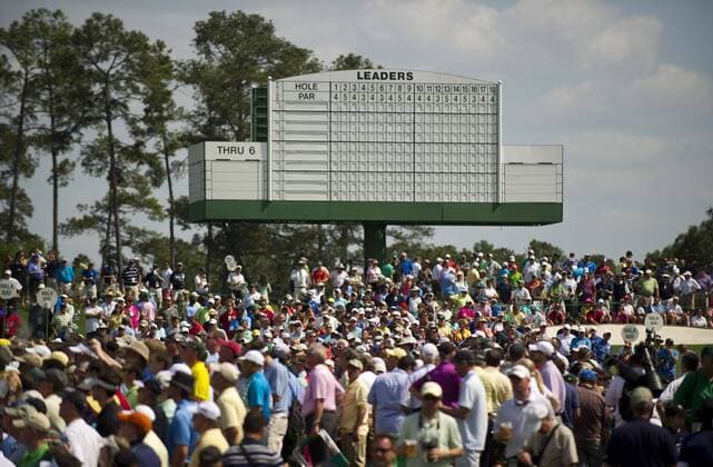 Patrons crowd around an empty score board during a practice round before the Master golf tournament at Augusta National Golf Club on April 9, 2013 in Augusta, Georgia.  AUG20130409359