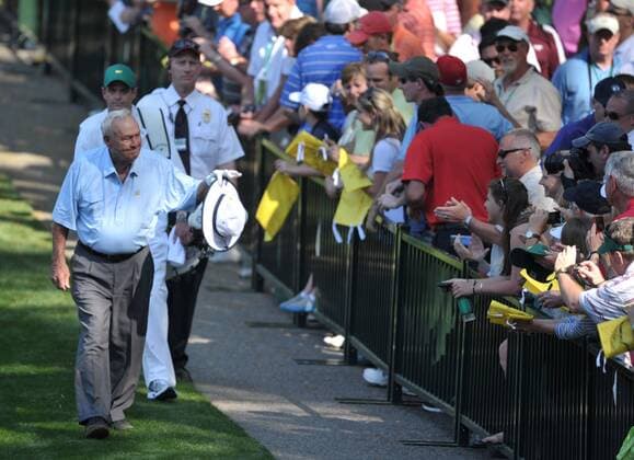 Arnold Palmer acknowledges the crowd as he walks to the 9th green during the Masters Par 3 Contest, a day before the beginning of the Masters tournament, at Augusta National, on April 10, 2013 in Augusta, Georgia.  AUG20130410343