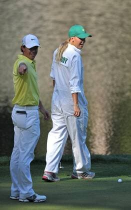 Rory McIlroy and his girlfriend Caroline Wozniacki line up a putt on the 9th green during the Masters Par 3 Contest a day before the beginning of the Masters tournament at Augusta National, on April 10, 2013 in Augusta, Georgia.  AUG20130410315