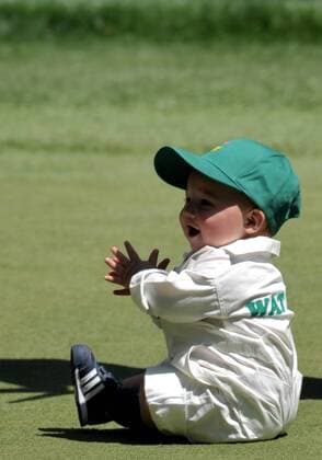 Bubba Watson s son Caleb claps as he sits on the 9th green during the Masters Par 3 Contest, a day before the beginning of the Masters tournament, at Augusta National, on April 10, 2013 in Augusta, Georgia.  AUG20130410327