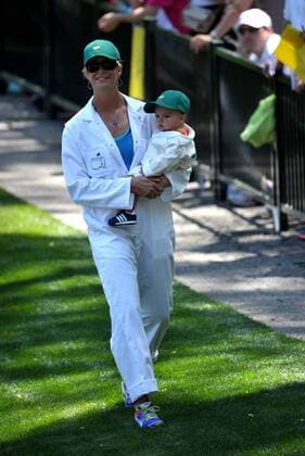 Bubba Watson s wife Angie holds their boy Caleb as they walk to the 9th green during the Masters Par 3 Contest, a day before the beginning of the Masters tournament, at Augusta National, on April 10, 2013 in Augusta, Georgia.  AUG20130410323