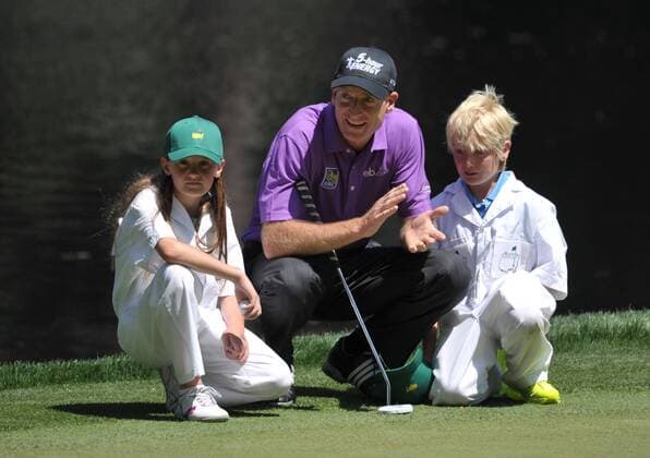 Jim Furyk sits with his children Tanner and Caleigh on the 9th green during the Masters Par 3 Contest, a day before the beginning of the Masters tournament, at Augusta National, on April 10, 2013 in Augusta, Georgia.  AUG20130410324