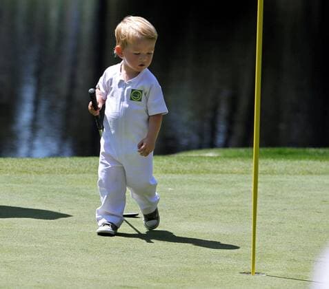 April 10, 2013 - Augusta, GA, USA - A 21-month-old Chase Merrick checks out the No. 4 pin as he walks with his father, John Merrick, during the Par 3 Contest at the Masters at Augusta National Golf Club on Wednesday, April 10, 2013, in Augusta, Georgia. Masters at Augusta National Golf Club - ZUMAm67