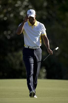 Tiger Woods tips his cap as he walks off of the 14th green during the second round of the Masters at Augusta National on April 12, 2013 in Augusta, Georgia.  AUG20130412373