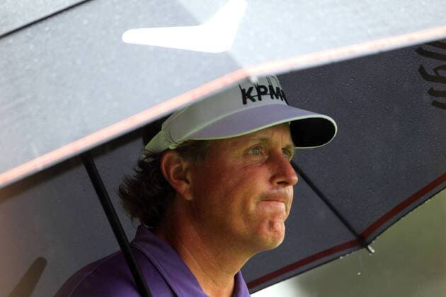 April 12, 2013 - Augusta, GA, USA - Phil Mickelson tries to stay dry as he prepares to hit his tee shot on the 4th hole during the second round of the Masters at Augusta National Golf Club, Friday, April 12, 2013, in Augusta, Georgia. Masters Tournament at Augusta National - ZUMAm67