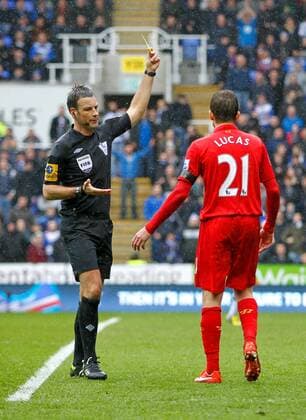 Football - 2012 2013 Premier League - Reading vs. Liverpool Referee Mr Mark Clattenburg shows the yellow card to Lucas Leiva of Liverpool 
