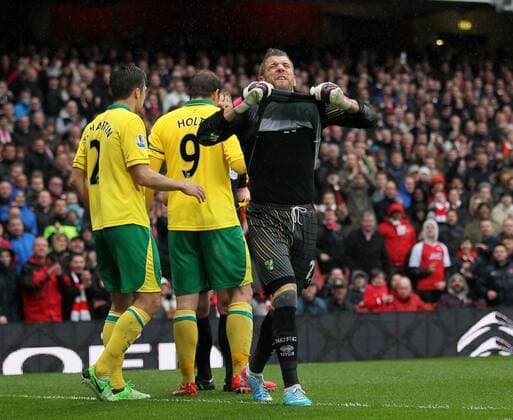 Norwich s Mark Bunn protests after the award of a penalty.. FC Arsenal London vs Norwich City - Barclays Premier League - Emirates Stadium, London- 12 04 13 - EDITORIAL USE ONLY. No use with unauthorised audio, video, data, fixture lists, club league logos or live services. Online in-match use limited to 120 images, no video emulation. No use in betting, games or single club league player publications.