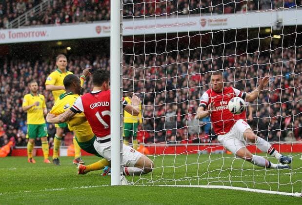 Norwich s Sebastian Bassong scoring an own goal to put Arsenal 2-1 up.. FC Arsenal London vs Norwich City - Barclays Premier League - Emirates Stadium, London- 12 04 13 - EDITORIAL USE ONLY. No use with unauthorised audio, video, data, fixture lists, club league logos or live services. Online in-match use limited to 120 images, no video emulation. No use in betting, games or single club league player publications.