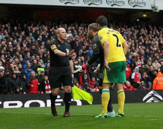 Norwich s players argue with assistant referee Richard West after the award of a penalty.. FC Arsenal London vs Norwich City - Barclays Premier League - Emirates Stadium, London- 12 04 13 - EDITORIAL USE ONLY. No use with unauthorised audio, video, data, fixture lists, club league logos or live services. Online in-match use limited to 120 images, no video emulation. No use in betting, games or single club league player publications.
