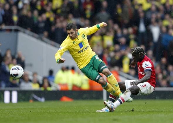 Arsenal s Bacary Sagna fouls Norwich s Bradley Johnson who went off injured.. FC Arsenal London vs Norwich City - Barclays Premier League - Emirates Stadium, London- 12 04 13 - EDITORIAL USE ONLY. No use with unauthorised audio, video, data, fixture lists, club league logos or live services. Online in-match use limited to 120 images, no video emulation. No use in betting, games or single club league player publications.