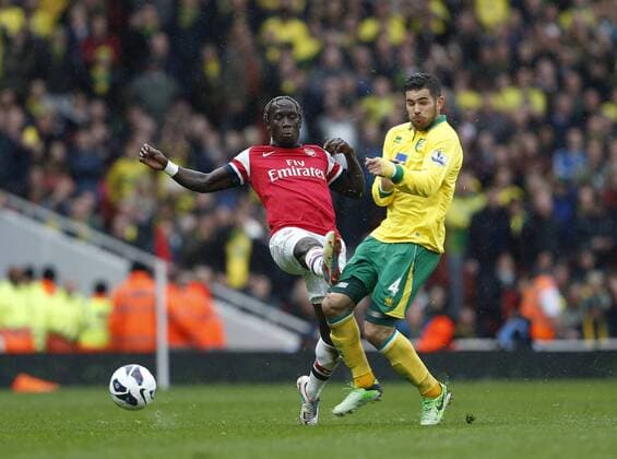 Arsenal s Bacary Sagna fouls Norwich s Bradley Johnson who went off injured.. FC Arsenal London vs Norwich City - Barclays Premier League - Emirates Stadium, London- 12 04 13 - EDITORIAL USE ONLY. No use with unauthorised audio, video, data, fixture lists, club league logos or live services. Online in-match use limited to 120 images, no video emulation. No use in betting, games or single club league player publications.