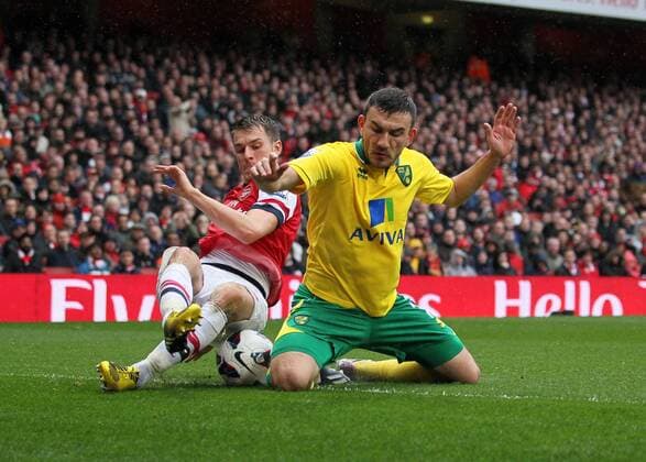 Arsenal s Aaron Ramsey tussles with Norwich s Robert Snodgrass.. FC Arsenal London vs Norwich City - Barclays Premier League - Emirates Stadium, London- 12 04 13 - EDITORIAL USE ONLY. No use with unauthorised audio, video, data, fixture lists, club league logos or live services. Online in-match use limited to 120 images, no video emulation. No use in betting, games or single club league player publications.