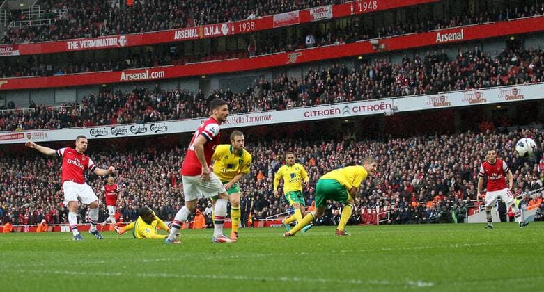 Arsenal s Lukas Podolski scoring his sides third goal.. FC Arsenal London vs Norwich City - Barclays Premier League - Emirates Stadium, London- 12 04 13 - EDITORIAL USE ONLY. No use with unauthorised audio, video, data, fixture lists, club league logos or live services. Online in-match use limited to 120 images, no video emulation. No use in betting, games or single club league player publications.