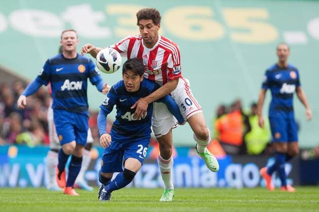 Football - 2012 2013 Premier League - Stoke City vs. Manchester United ManU Shinji Kagawa of Manchester United ManU battles Stoke s Ryan Shotton at the Britannia Stadium 