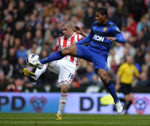 Jonathan Walters of Stoke City challenged by Luis Antonio Valencia of Manchester United ManU - Barclays Premier League - Stoke City vs Manchester Utd - Britannia Stadium - Stoke - England - 14 04 13 - EDITORIAL USE ONLY. No use with unauthorised audio, video, data, fixture lists, club league logos or live services. Online in-match use limited to 120 images, no video emulation. No use in betting, games or single club league player publications.
