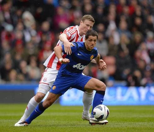 Javier Hernandez of Manchester United ManU tussles with Robert Huth of Stoke City - Barclays Premier League - Stoke City vs Manchester Utd - Britannia Stadium - Stoke - England - 14 04 13 - EDITORIAL USE ONLY. No use with unauthorised audio, video, data, fixture lists, club league logos or live services. Online in-match use limited to 120 images, no video emulation. No use in betting, games or single club league player publications.